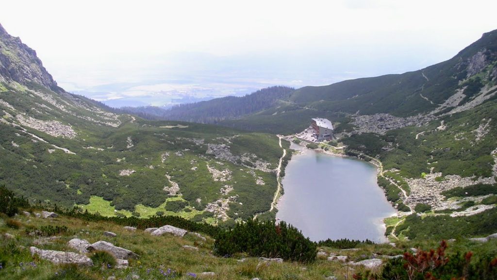 Widok na schronisko górskie i jezioro ze szlaku. Tatry słowackie.